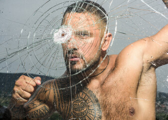 Sexy gangster man. Dangerous criminal, hooligan guy on cracked bullet glass.