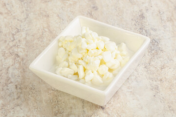 Grained cottage cheese in the bowl