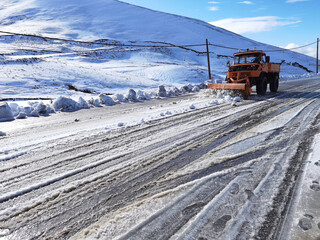 snowplough shovel machin cleaning the road from snow and  ice in winter