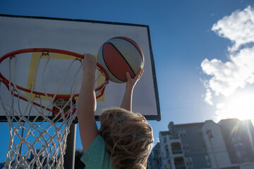 Basketball Slam Dunks of sporty kids basketball player. Kid sportsman. © Volodymyr