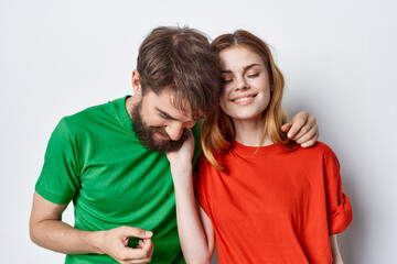 a young couple multicolored t-shirts communication quarrel studio lifestyle