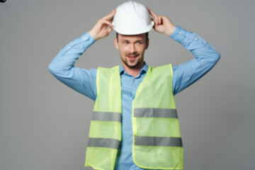 male builder in working form construction work light background