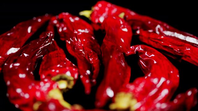 Hot red chili pepper on black background. Harvest of red pepper.