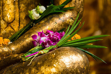 Meditation Buddha statue with flowers.
