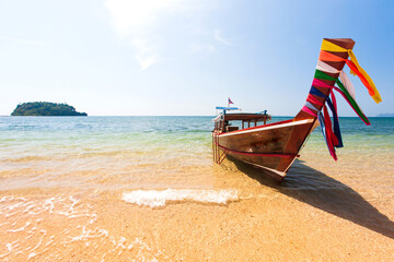 Fototapeta na wymiar A traditional wooden boat on a beach in summer.