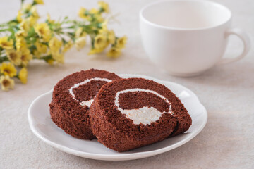 Chocolate roll cake on white plate