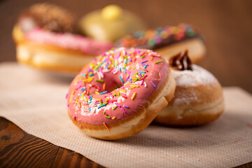 delicious sweet round donuts with colored sprinkles