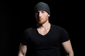 Naklejka premium Confident attractive man with serious face on black.