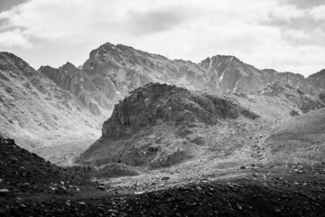 Beautiful dramatic monochrome landscape: mountains, hills and cloudy sky. High-contrast image 