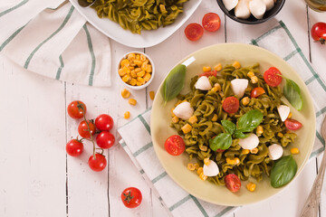Fusilli pasta with cherry tomatoes and sweet corn.