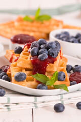 Waffles with blueberries and jam. 