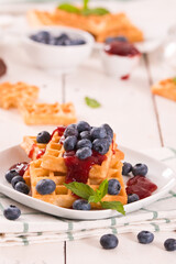 Waffles with blueberries and jam. 