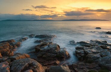 Obraz premium Beautiful coastal seascape sunset scenery of rocky coast at wild atlantic way in county Galway, Ireland, long, exposure, nature background, wallpaper