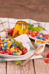Colored gnocchi with vegetables and sweet corn.