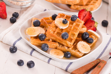 Waffles with blueberries, bananas and honey.