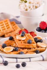 Waffles with blueberries, bananas and honey.