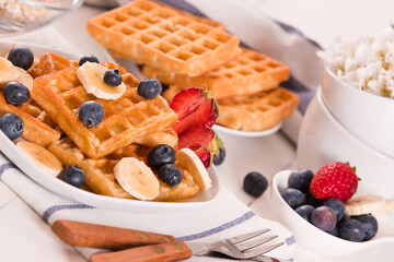 Waffles with blueberries, bananas and honey.