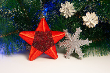 New Year's background of green branches and garlands and ornaments in the form of silver stars with balls