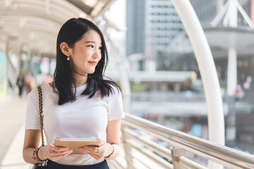 Young adult business working asian woman interactive digital tablet for corporate with team via...
