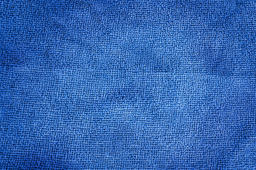 Close-up of abstract fabric texture as background for text or interior design. Blue artificial fabric texture.  