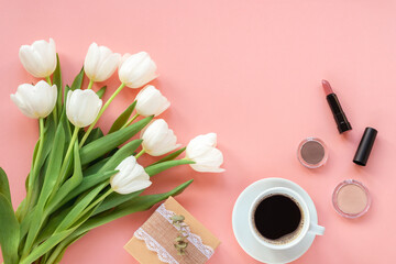 Obraz na płótnie Canvas Cup of coffee, gift box, make up tools, cosmetics and bouquet of tulips on pink background, top view. Women's day or Mother's day concept. Creative flat lay