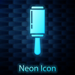 Glowing neon Adhesive roller for cleaning clothes icon isolated on brick wall background. Getting rid of debris, dust, hair, fluff, pet wool. Vector Illustration