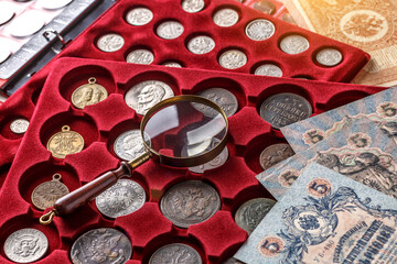 Numismatics. Old collectible coins made of silver on a wooden table.Coins in the album.Collection...