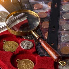Numismatics. Old collectible coins made of silver on a wooden table.Coins in the album.Collection...
