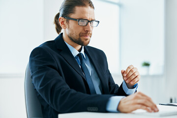 male manager with glasses works in an office or computer