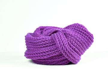 Hand-knitted scarf on a white table Velvet violet