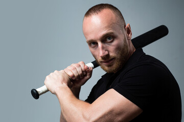 Guy with baseball bat for fighting. Dangerous man with serious emotion. Self defense.