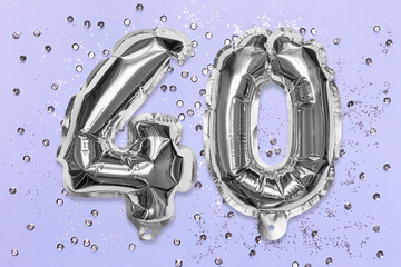 Silver foil balloon number, digit forty on a lilac background with sequins. Birthday greeting card with inscription 40. Anniversary concept. Top view. Numerical digit. Celebration event, template.