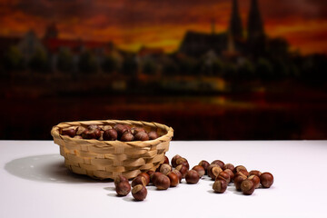 hazelnuts in a basket on a white background