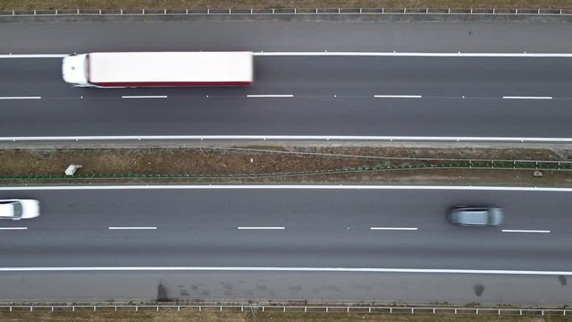 Cars movement on a highway, aerial view. Car traffic on a suburban highway, top view. Logistic and travel concept