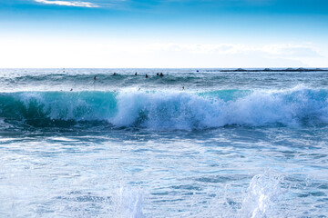 Group of surfers enjoying sport and waves in the atlantic ocean