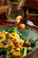 Eating on gourmet salad with seafood and greens