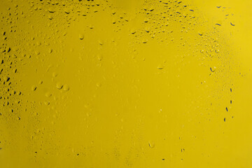 Yellow backgrond with water drops.