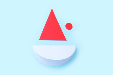 Fototapeta premium DIY and kid's creativity. Step by step instruction: how to make Santa claus from paper. Step2 cut out cap and circle for Santa's face from paper. Children's Christmas and New year