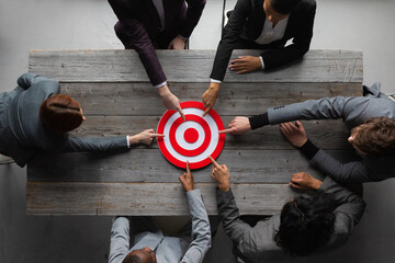 Business people pointing at target