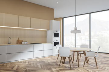 Beige kitchen interior with table and chairs, parquet floor and window