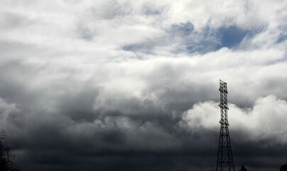 mobile phone tower and cloudy sky