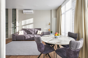 a soft large sofa in the dining area of the apartment