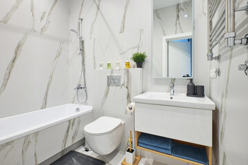 bright bathroom with a stone pattern on the tile
