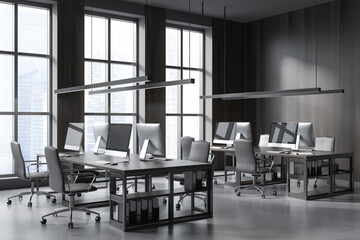Grey business room interior with armchairs and pc on concrete floor, city view