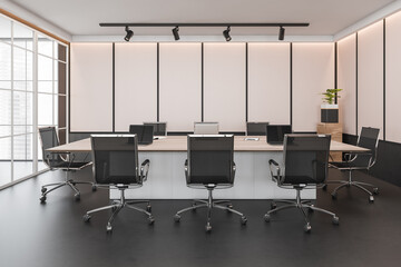 Dark conference room interior with furniture and windows