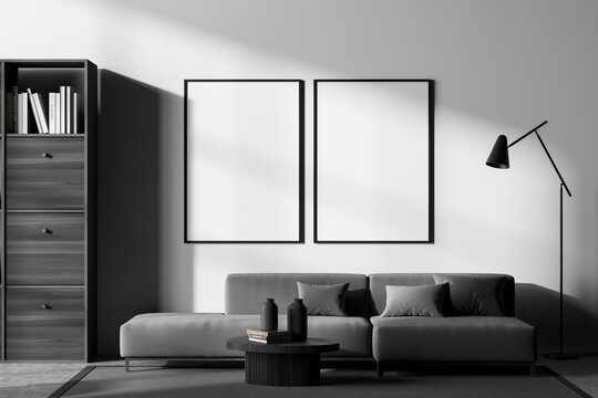 Dark waiting room interior with sofa on carpet, shelf and mockup posters
