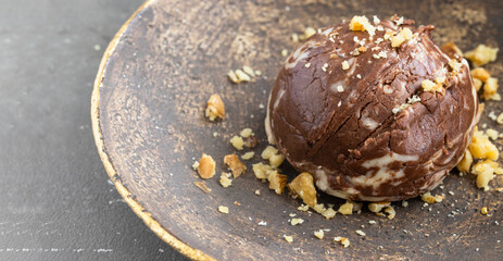 Two chocolate  ice cream ball  with nuts on the brown plate .Lrge image for banner