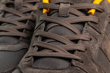 Close up of shoelaces on gray shoes.