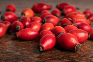 Rose hips on wooden background. Close up