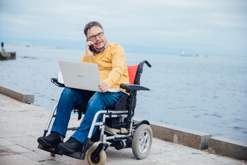 a man with disabilities in a wheelchair business negotiations by phone